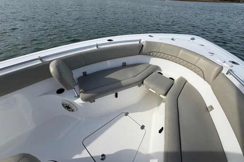 Slide: The Image of 2021 Sportsman Heritage 251 Center Console boat with spacious seating on calm water. - 28