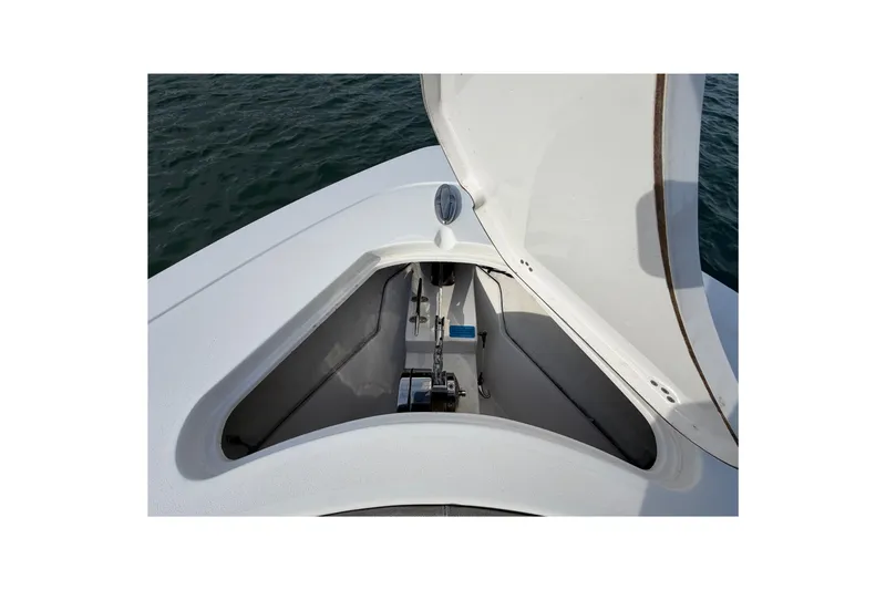 Slide: The Image of 2021 Sportsman Heritage 251 Center Console anchor compartment open on calm water. - 30