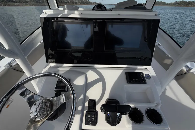 Slide: The Image of 2021 Sportsman Heritage 251 Center Console helm with dual displays and steering wheel. - 38