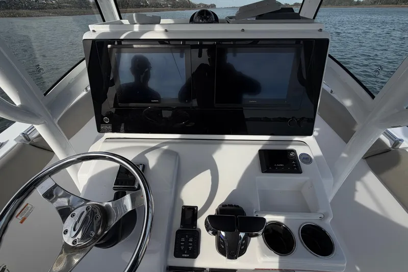 Slide: The Image of 2021 Sportsman Heritage 251 Center Console dashboard with dual screens and steering wheel. - 39