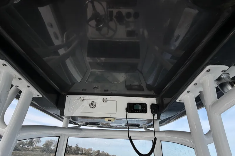 Slide: The Image of 2021 Sportsman Heritage 251 Center Console boat interior with radio and storage compartment. - 40