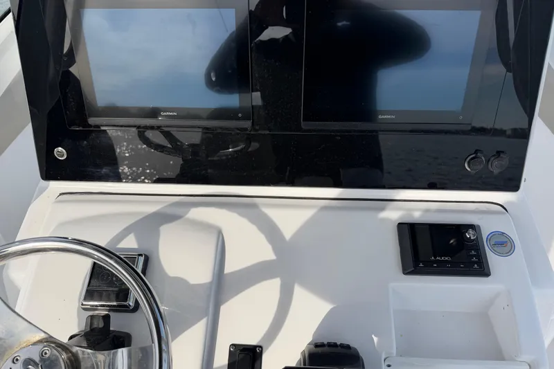 Slide: The Image of 2021 Sportsman Heritage 251 Center Console dashboard with dual Garmin displays and JL Audio system. - 45