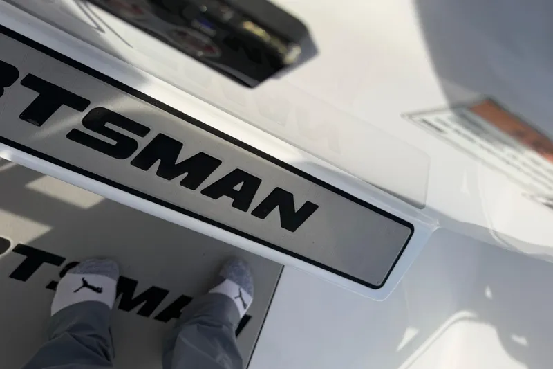 Slide: The Image of 2021 Sportsman Heritage 251 Center Console boat deck with logo and person in socks. - 46