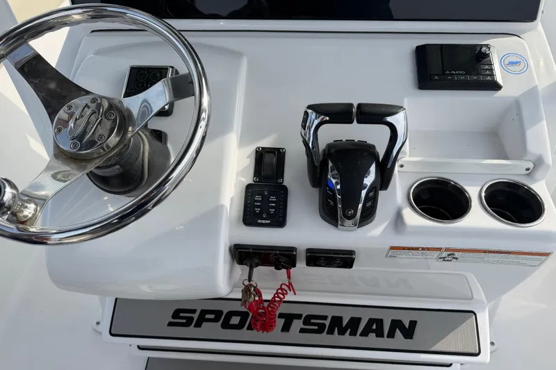 Slide: The Image of 2021 Sportsman Heritage 251 Center Console helm with steering wheel and controls. - 48