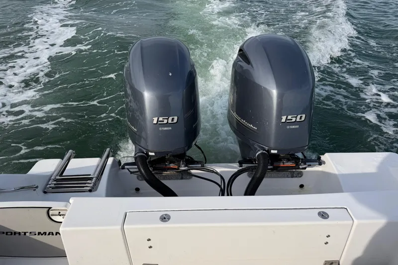 Slide: The Image of 2021 Sportsman Heritage 251 Center Console with twin Yamaha 150 engines on water. - 49
