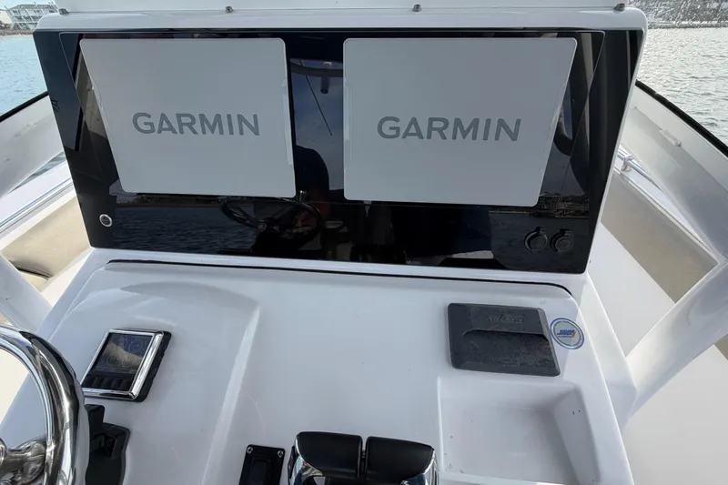 Slide: The Image of 2021 Sportsman Heritage 251 Center Console dashboard with dual Garmin displays. - 50