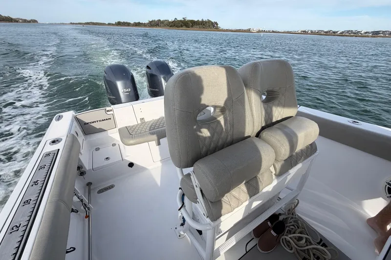 Slide: The Image of 2021 Sportsman Heritage 251 Center Console boat with dual engines on open water. - 51