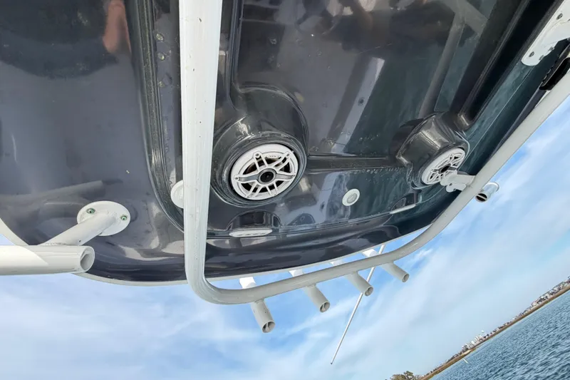 Slide: The Image of 2021 Sportsman Heritage 251 Center Console boat underside with speakers and rod holders. - 52