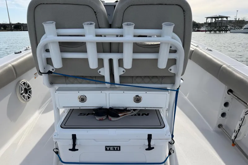 Slide: The Image of 2021 Sportsman Heritage 251 Center Console boat interior with rod holders and Yeti cooler. - 53