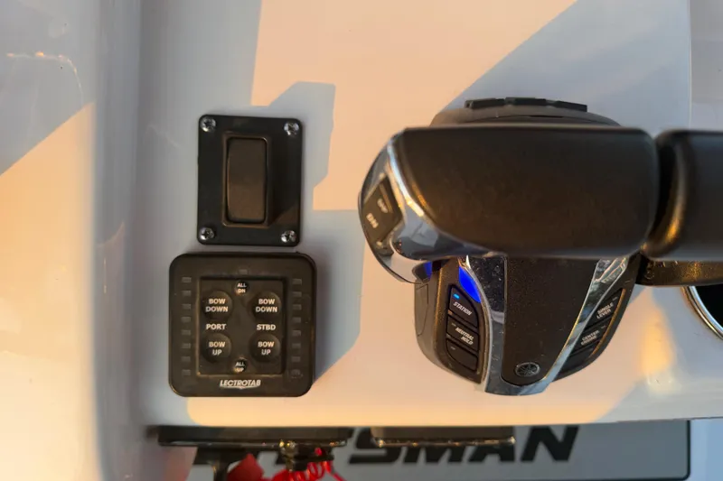 Slide: The Image of 2021 Sportsman Heritage 251 Center Console controls with throttle and trim tab switches. - 55