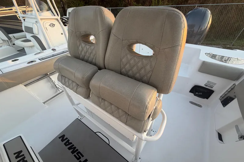 Slide: The Image of 2021 Sportsman Heritage 251 Center Console boat with cushioned seating and modern design. - 57