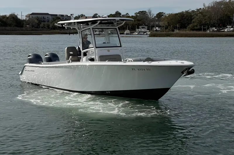 Slide: The Image of 2021 Sportsman Heritage 251 Center Console boat cruising on calm water. - 6