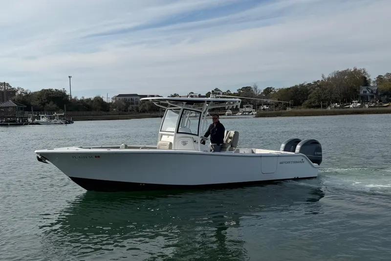 Slide: The Image of 2021 Sportsman Heritage 251 Center Console boat cruising on calm waters. - 7