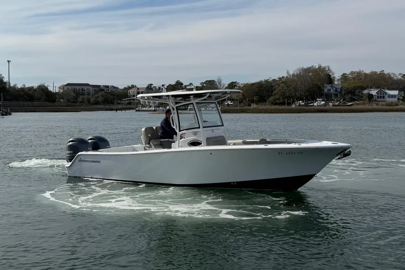 Slide: The Image of 2021 Sportsman Heritage 251 Center Console boat cruising on a calm waterway. - 8