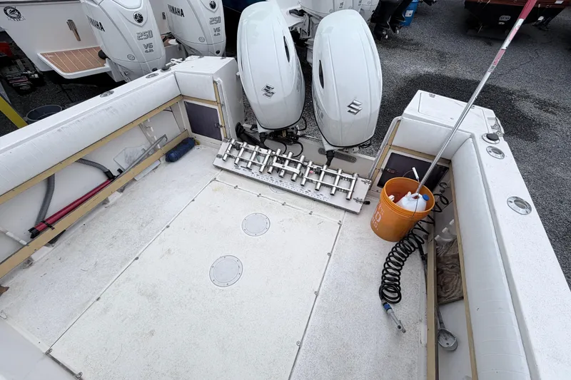 Slide: The Image of 1990 Grady-White Sailfish 25 Sportbridge boat deck with dual Suzuki outboard engines. - 4