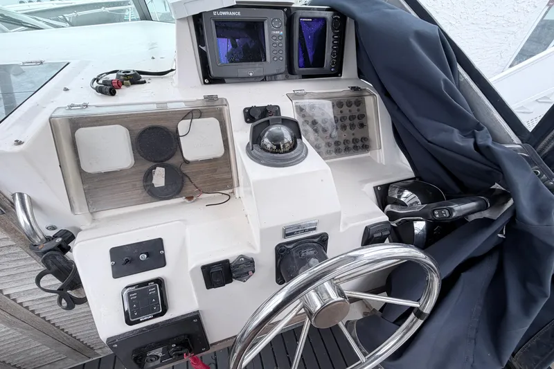 Slide: The Image of 1990 Grady-White Sailfish 25 Sportbridge helm with steering wheel and navigation equipment. - 5