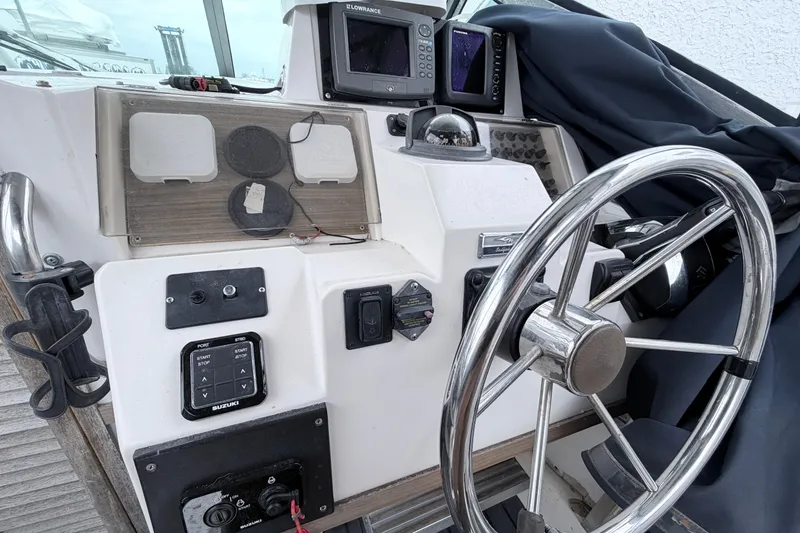 Slide: The Image of 1990 Grady-White Sailfish 25 Sportbridge helm with steering wheel and navigation equipment. - 6