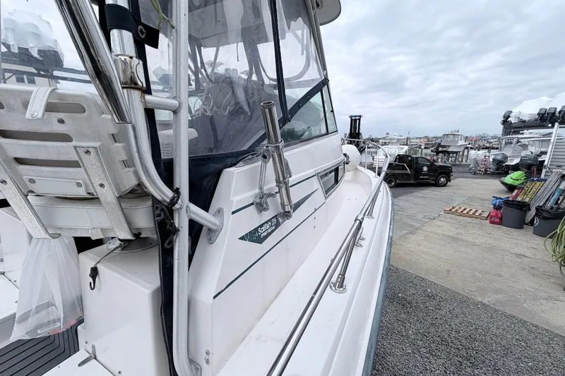 Slide: The Image of 1990 Grady-White Sailfish 25 Sportbridge boat docked at a marina. - 9