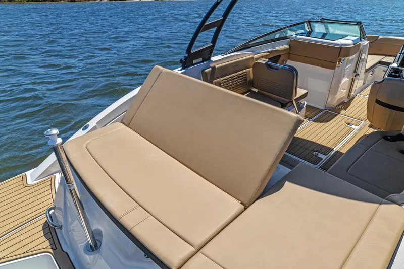Slide: The Image of 2024 Sea Ray SPX 230 Outboard boat interior with tan seating and wooden deck. - 15