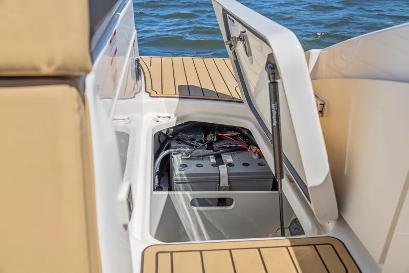 Slide: The Image of 2024 Sea Ray SPX 230 Outboard boat battery compartment open on deck. - 17