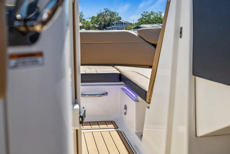 Slide: The Image of 2024 Sea Ray SPX 230 Outboard interior with beige seating and sleek design. - 18