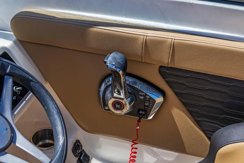 Slide: The Image of 2024 Sea Ray SPX 230 Outboard throttle control and steering wheel detail. - 21