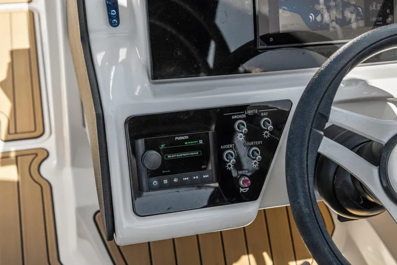 Slide: The Image of 2024 Sea Ray SPX 230 Outboard dashboard with control panel and steering wheel. - 22