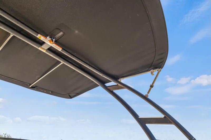 Slide: The Image of 2024 Sea Ray SPX 230 Outboard boat canopy against blue sky. - 23