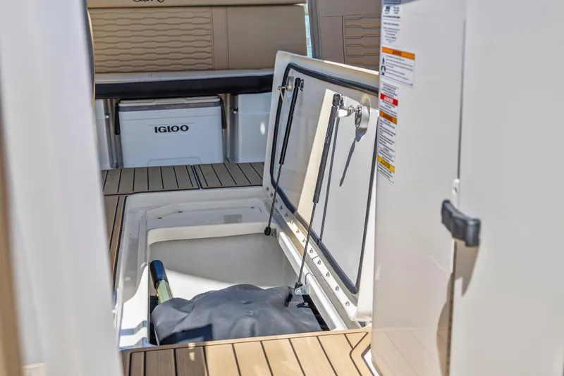 Slide: The Image of 2024 Sea Ray SPX 230 Outboard boat storage compartment with Igloo cooler. - 25