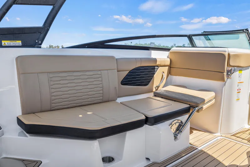 Slide: The Image of 2024 Sea Ray SPX 230 Outboard interior seating with beige upholstery and sleek design. - 27