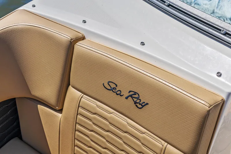 Slide: The Image of 2024 Sea Ray SPX 230 Outboard boat seat with logo, featuring tan upholstery. - 29