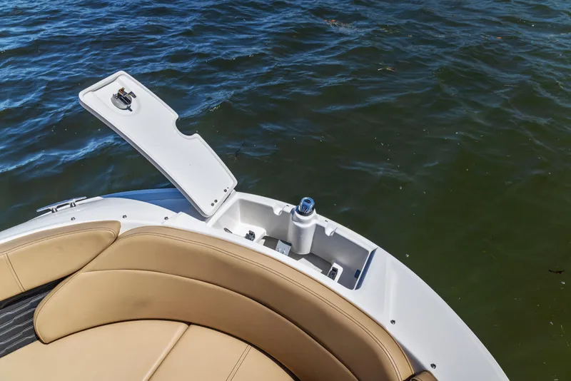 Slide: The Image of 2024 Sea Ray SPX 230 Outboard boat with open storage compartment on water. - 31
