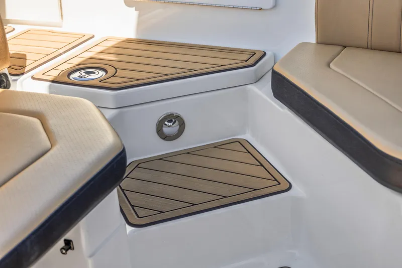 Slide: The Image of 2024 Sea Ray SPX 230 Outboard interior with tan seating and wood accents. - 34