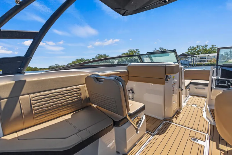 Slide: The Image of 2024 Sea Ray SPX 230 Outboard interior with tan seating and sleek design. - 38