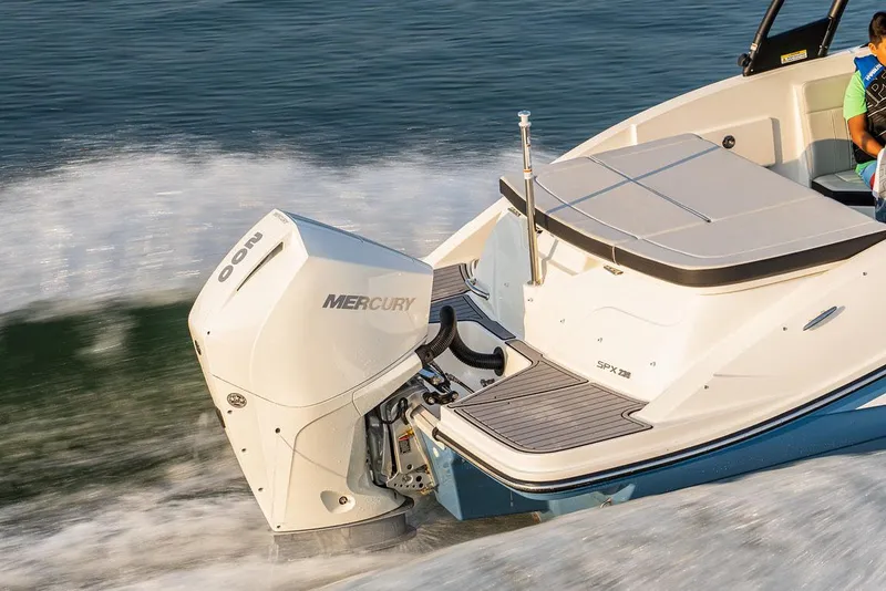 Slide: The Image of 2024 Sea Ray SPX 230 Outboard boat on serene lake with scenic shoreline. - 4