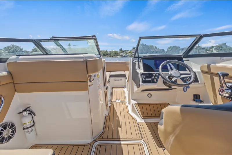 Slide: The Image of 2024 Sea Ray SPX 230 Outboard boat interior with modern dashboard and seating. - 41