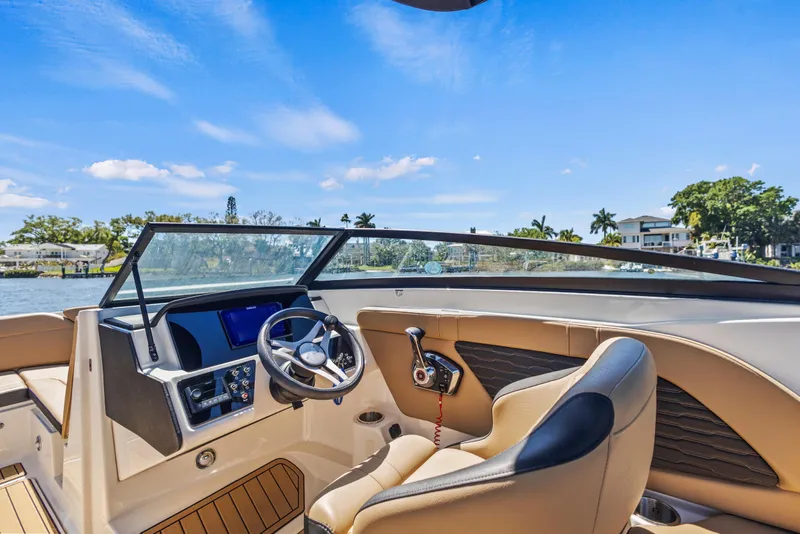 Slide: The Image of 2024 Sea Ray SPX 230 Outboard boat interior with steering wheel and dashboard controls. - 46