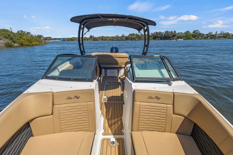 Slide: The Image of 2024 Sea Ray SPX 230 Outboard boat interior with tan seating on a sunny day. - 49