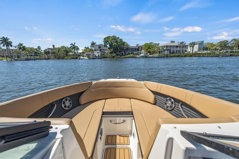 Slide: The Image of 2024 Sea Ray SPX 230 Outboard boat interior with waterfront view. - 50