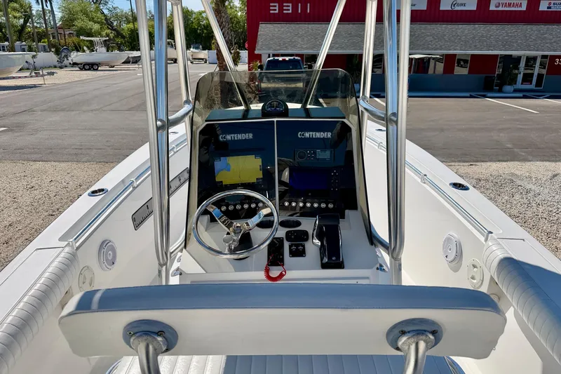 Slide: The Image of 2003 Contender 21 Open boat dashboard with steering wheel and navigation equipment. - 14