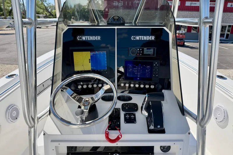 Slide: The Image of 2003 Contender 21 Open boat dashboard with steering wheel and navigation controls. - 15