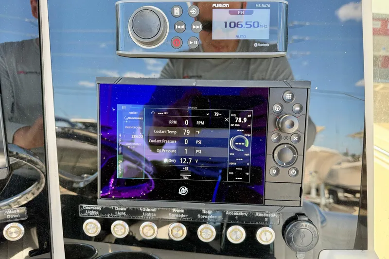 Slide: The Image of Dashboard of a 2003 Contender 21 Open boat with digital displays and controls. - 17