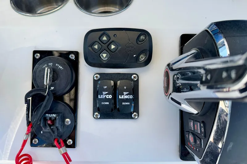 Slide: The Image of Control panel of a 2003 Contender 21 Open boat with switches and throttle. - 19