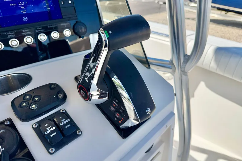 Slide: The Image of Control panel of a 2003 Contender 21 Open boat with throttle and switches. - 20