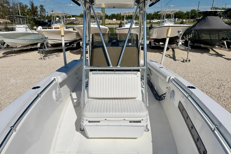 Slide: The Image of 2003 Contender 21 Open boat interior with seating and console, parked among other boats. - 22