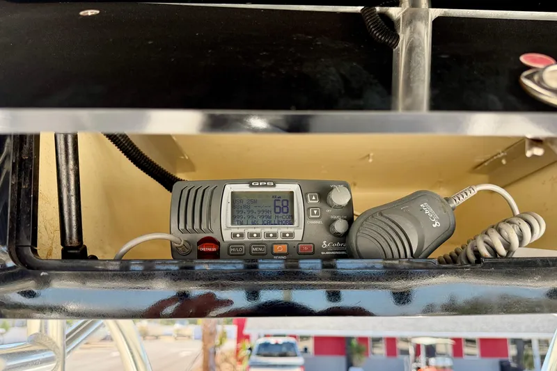 Slide: The Image of Cobra marine radio installed on a 2003 Contender 21 Open boat dashboard. - 23