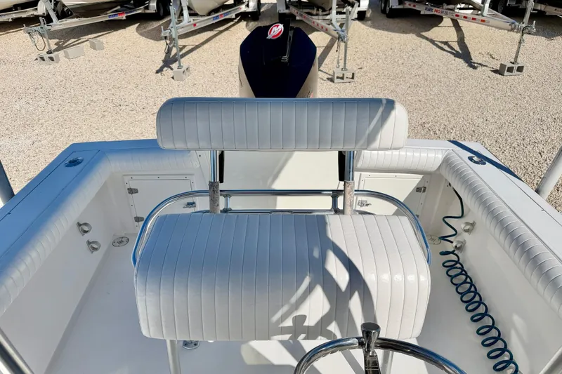 Slide: The Image of 2003 Contender 21 Open boat interior with white seating and steering wheel. - 25