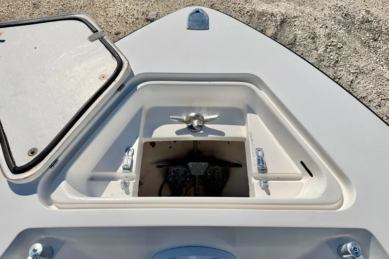 Slide: The Image of Open anchor compartment on 2003 Contender 21 Open boat, showing storage space. - 28