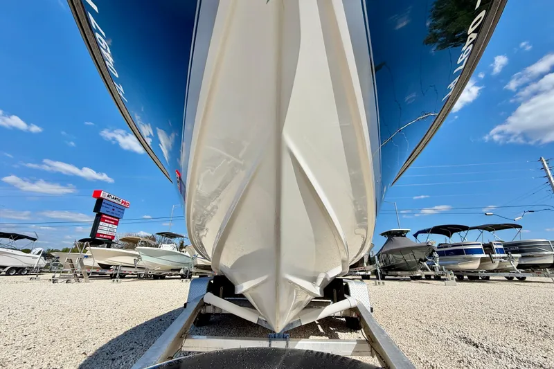 Slide: The Image of 2003 Contender 21 Open boat on trailer at dealership under blue sky. - 33