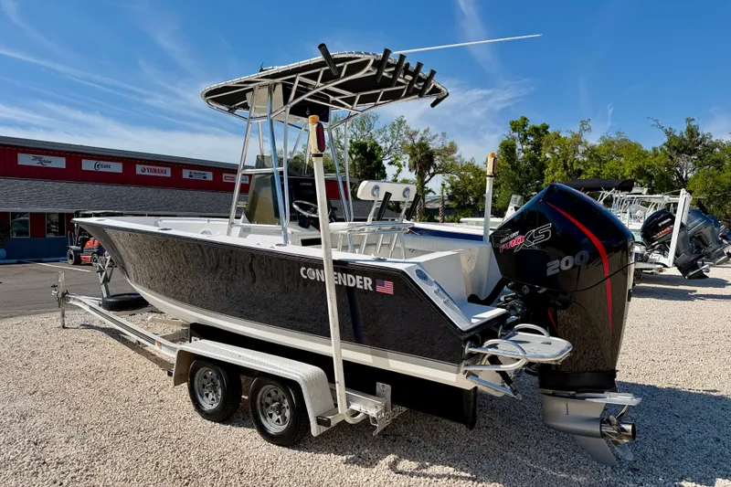 Slide: The Image of 2003 Contender 21 Open boat on trailer with Mercury 200 engine, parked outdoors. - 6